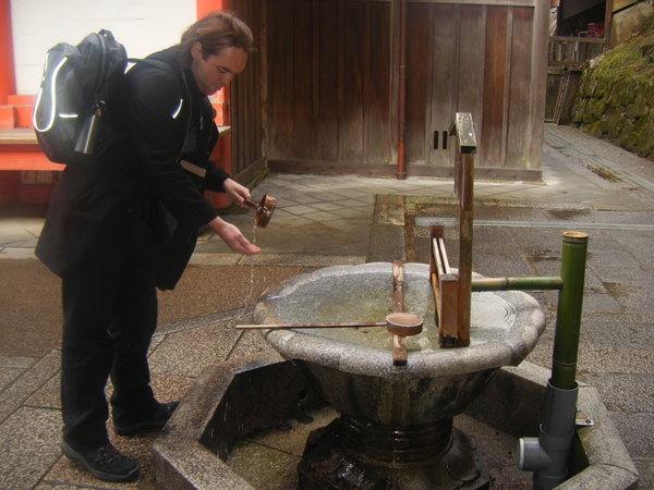 Mark washing his hands in sacred water