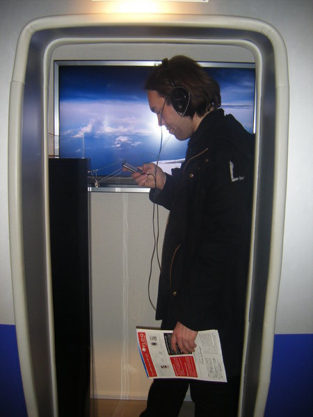 Mark testing the headphones on a "plane"