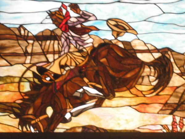 A cowboy stained glass window