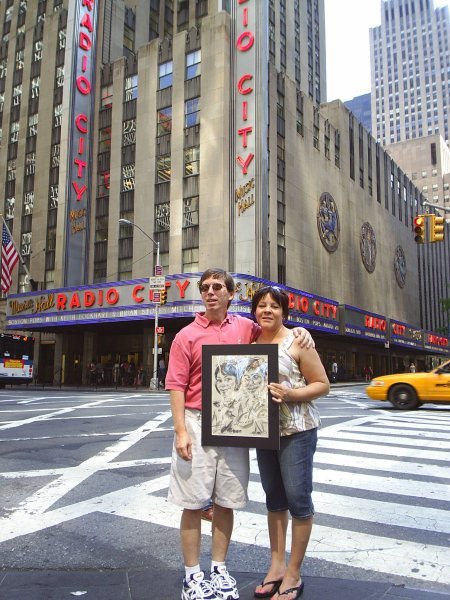 Us with our caricature in front of Radio City Music Hall