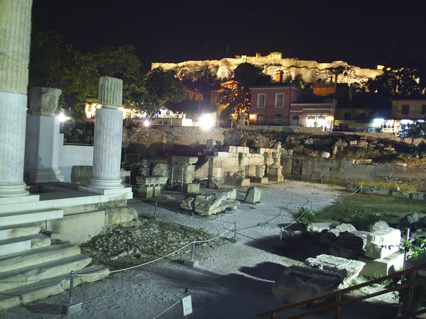 Ancient ruins in Athens with the Acropolis in the background.