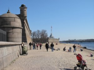 Fortress wall and sandy beach on edge of Neva River