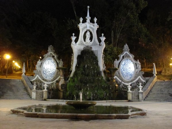 An impressive and mossy fountain by night
