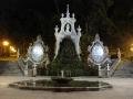 An impressive and mossy fountain by night