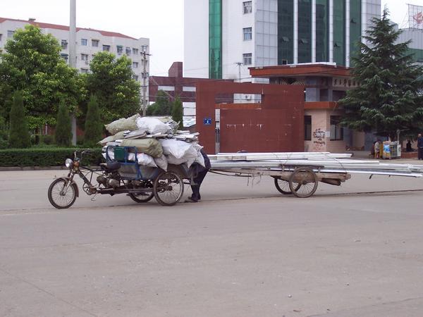 Motorcyle 'truck' pulling a hand cart loaded with steel 