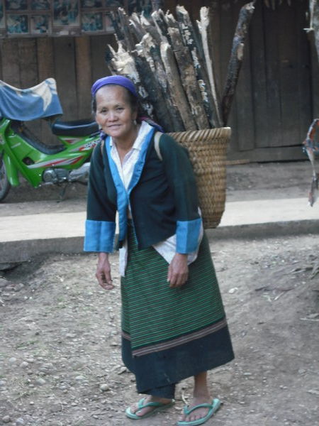 Hmong woman carrying firewood