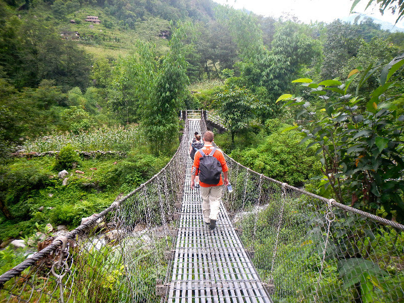 Mike Crossing the River on a Suspension Bridge