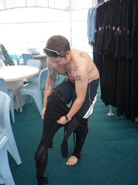 James trying to get into his wetsuit