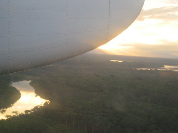 The view of the sun going down over the jungle from our plane