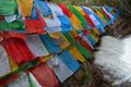 prayer flags and gushing water