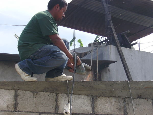 Cuchi trimming the metal poles