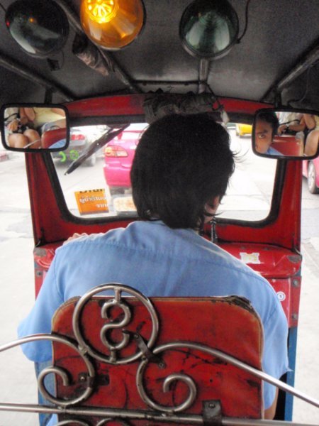 in the back of one of the frustrating tuk tuks (you can see us in the driver's side mirrors!)