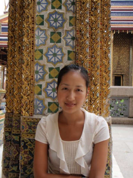 jean in front of intricate tiling and gold leaf at the grand palace