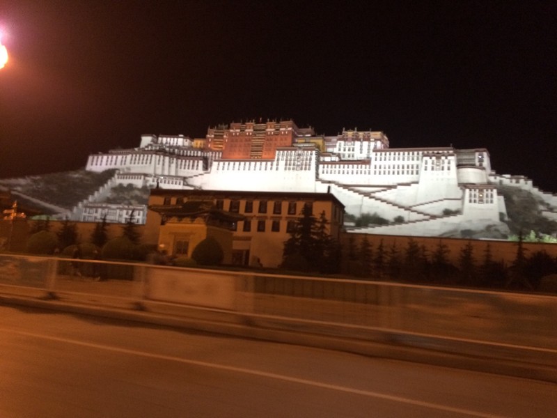 Potala Palace lit up at night - drive by shot
