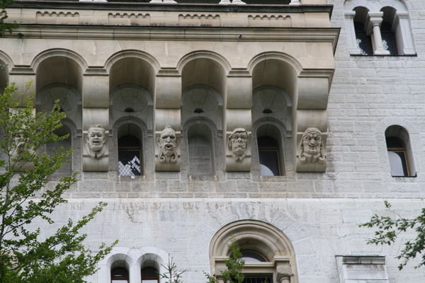 Funny faces on side of castle