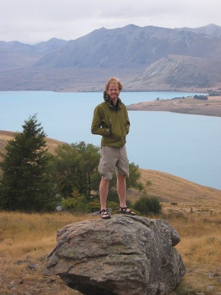 Jeremy on a rock (not in a rock) overlooking Lake Tekapoa...