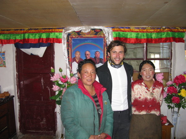 With some tibetan shop owners - notice HH in the background...this picture is only allowed outside of Tibet- picture taken in Qinghai province