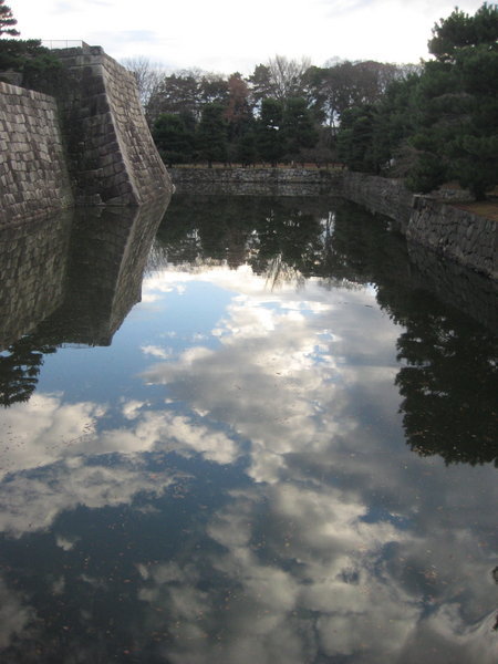 Japanese clouds reflected in a moat surrounding the castle