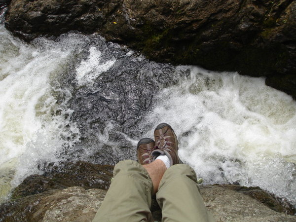 Sitting on a rock between two waterfalls.