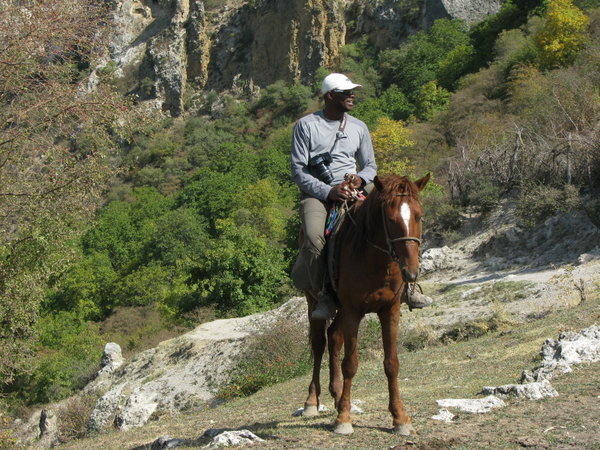 Kwesi on a horse in Kyrgyzstan