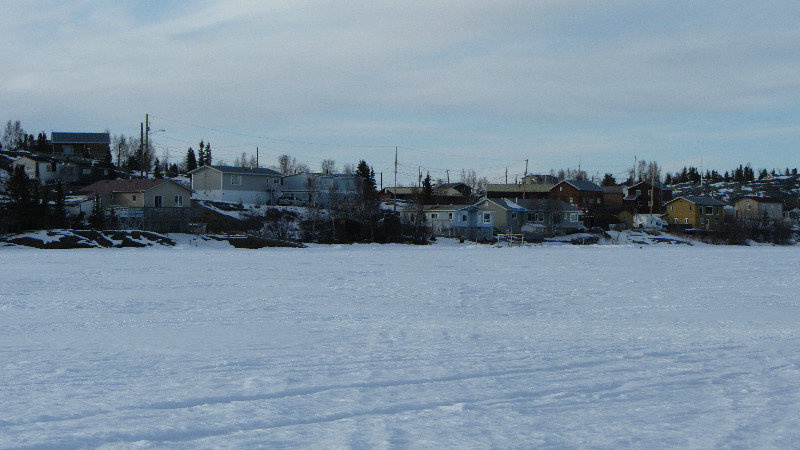 View of homes along the frozen lake