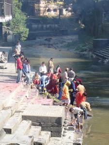 People offering flowers to the river
