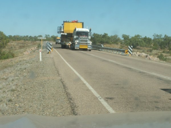 Oversized truck crossing bridge