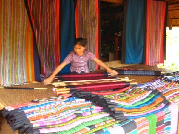 A lady doing traditional weaving