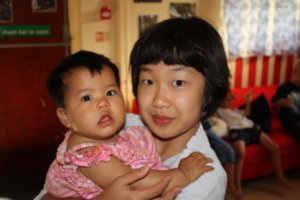 Ji Na holding baby Kristal, Tiem's cousin