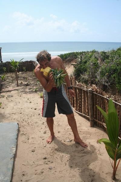 Wim eating a pineapple