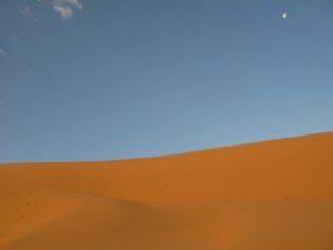 Moon over sand dunes
