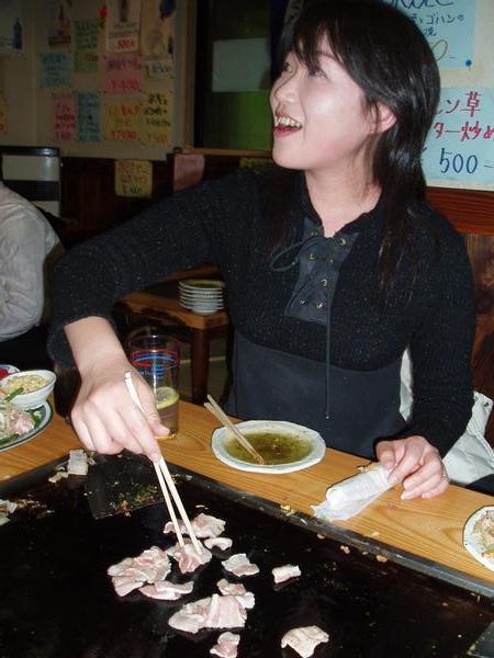 Yuriko cooking at the table