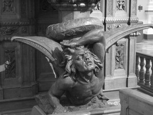 A wooden sculpture of the devil under the pulpit in the cathedral