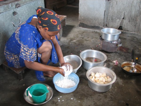 housegirl making coconut milk