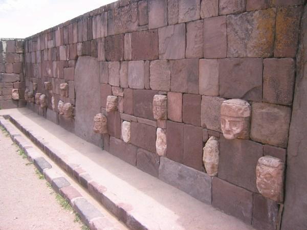 Stone faces line the walls of the semi-subterranean temple. 