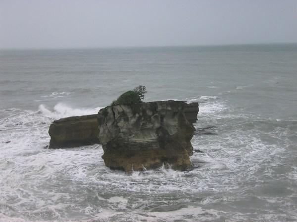 Sea surging around some of the stacked rock formations