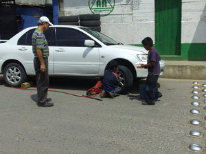 Young boys fixing our flat tyre