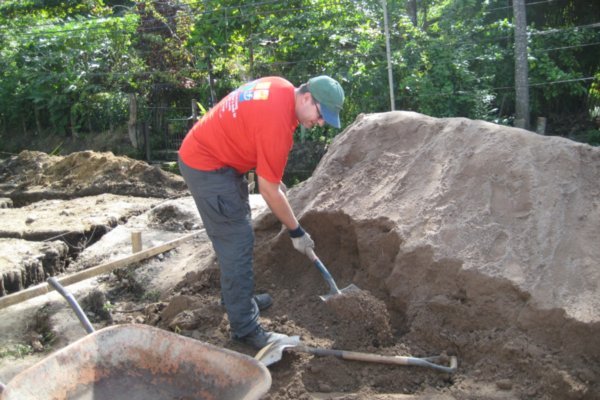 Michael shovels sand for cement