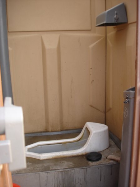 Squat toilet Porta-Potty at the beach
