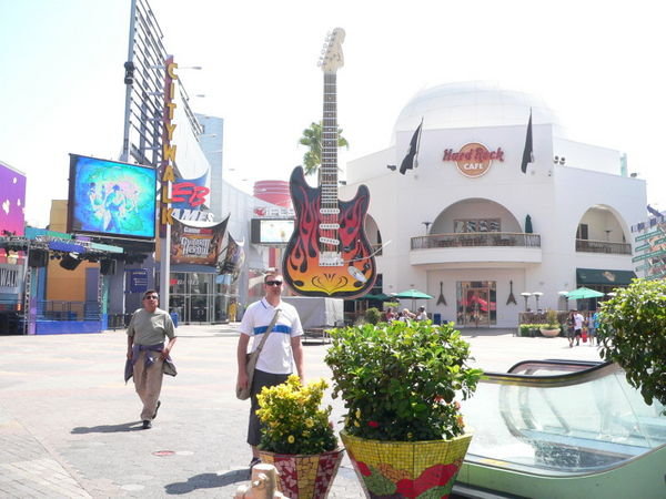Matt standing by a huge guitar next to the Hard Rock Cafe