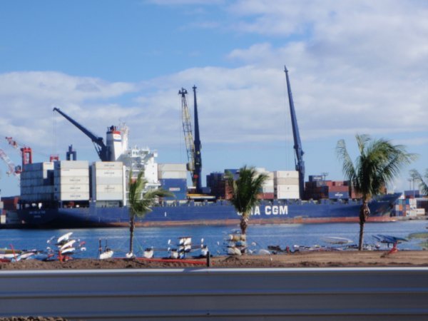 A container ship in the harbour that was stacked to the brim.