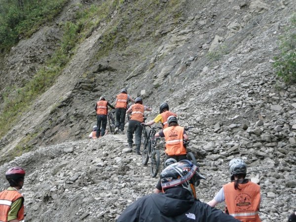 Hauling the bikes over the landslide! 