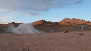 Geysers and the sunrise-lit mountains