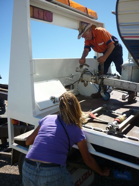 Sarah works the controls of the tow truck