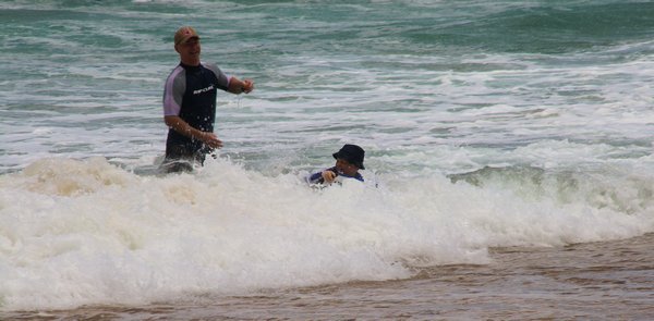 Grants friend and son surfing - laughing all the way