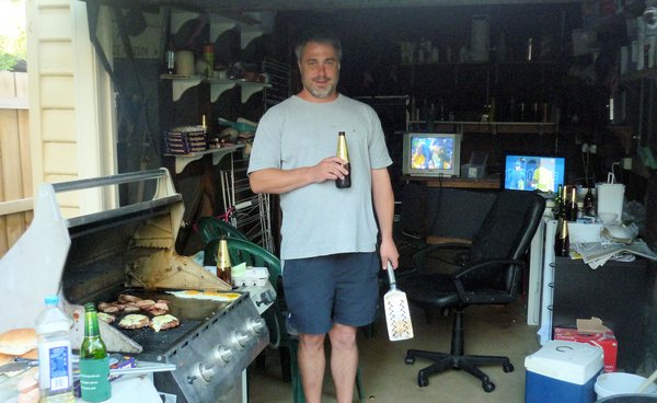 Grant in his 'manhole'.  Cricket on one TV, Tennis on the other, beer and BBQ burgers.  What more could you possibly want!