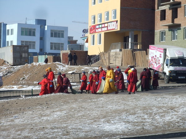 the monks cleaning the streets