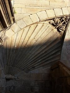 The stone work scallop shell by the stairs leading in to the Cathedral at the pilgrims door