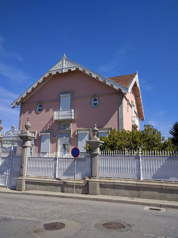 Pink house with unusual roof line decorations