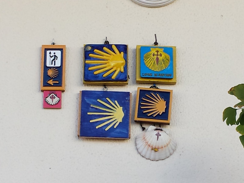 different camino patches, plaques, and waymarks